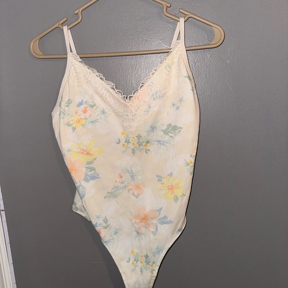 Women’s white floral one piece with lacing at the top.